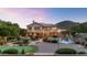 Lush backyard featuring a pool with a waterfall, trampoline, and putting green, perfect for outdoor enjoyment at 1922 E Saltsage Dr, Phoenix, AZ 85048