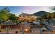 Expansive backyard with pool, fire pit, lush greenery, and mountain views at dusk at 1922 E Saltsage Dr, Phoenix, AZ 85048