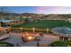 Fire pit area with seating and string lights overlooking a lush golf course and mountain views at 1922 E Saltsage Dr, Phoenix, AZ 85048