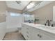 Well-lit bathroom featuring double sinks, modern fixtures, and a shower-tub combination at 1922 E Saltsage Dr, Phoenix, AZ 85048