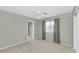Neutral bedroom with a ceiling fan, gray curtains, light carpet, and a standard closet at 1922 E Saltsage Dr, Phoenix, AZ 85048