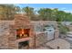 Outdoor fireplace and stainless steel grill create a perfect outdoor cooking and entertaining area at 1922 E Saltsage Dr, Phoenix, AZ 85048