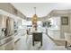 Spacious kitchen with stainless steel appliances, white cabinetry, and a center island with seating at 1922 E Saltsage Dr, Phoenix, AZ 85048