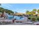 Backyard pool with a rock waterfall, lush greenery, lounge chairs, and decorative string lights at 1922 E Saltsage Dr, Phoenix, AZ 85048