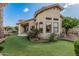 Beautiful backyard with a putting green, lush landscaping, and a tranquil water feature at 2535 N Pinnule Cir, Mesa, AZ 85215