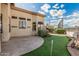 Spacious backyard with a putting green and sports court, perfect for outdoor activities and entertainment at 2535 N Pinnule Cir, Mesa, AZ 85215