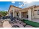 Inviting backyard featuring a pond, stone path, and covered patio, perfect for outdoor living at 2535 N Pinnule Cir, Mesa, AZ 85215