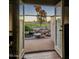 Inviting view of the backyard from inside, featuring a stone-lined pond, palm trees, and a putting green at 2535 N Pinnule Cir, Mesa, AZ 85215
