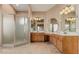 Bright bathroom featuring double vanity, framed mirrors, tiled floor and walk-in shower at 2535 N Pinnule Cir, Mesa, AZ 85215
