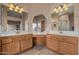 Bright bathroom featuring double vanity, framed mirrors and separate tub and shower at 2535 N Pinnule Cir, Mesa, AZ 85215