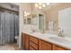 Bright bathroom featuring double vanity, framed mirror and separate toilet and shower at 2535 N Pinnule Cir, Mesa, AZ 85215