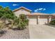 Beige home with tile roof and desert landscaping, including small palm trees, gravel, and a two-car garage at 2535 N Pinnule Cir, Mesa, AZ 85215