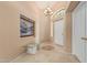 Warm and inviting foyer with tile flooring, chandelier, artwork, and a decorative accent window at 2535 N Pinnule Cir, Mesa, AZ 85215