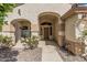 Inviting front porch with a decorative archway, seating, and a view of the desert-style landscape at 2535 N Pinnule Cir, Mesa, AZ 85215