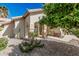Charming home featuring drought-resistant landscaping with cacti and a welcoming front entrance at 2535 N Pinnule Cir, Mesa, AZ 85215