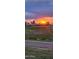 Picturesque sunset over a lush golf course, highlighting the tranquil environment and stunning views at 2535 N Pinnule Cir, Mesa, AZ 85215