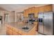 Spacious kitchen with stainless steel appliances, center island with sink, and wooden cabinets at 2535 N Pinnule Cir, Mesa, AZ 85215