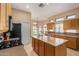 Well-lit kitchen with a large island, plentiful storage, and an adjacent breakfast nook at 2535 N Pinnule Cir, Mesa, AZ 85215