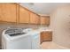 Spacious laundry room equipped with sink, countertop, overhead cabinets and laundry machines at 2535 N Pinnule Cir, Mesa, AZ 85215
