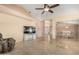 Open-concept living room featuring tile floors, neutral color scheme, and seamless transition to dining area at 2535 N Pinnule Cir, Mesa, AZ 85215