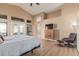 Spacious main bedroom with vaulted ceilings, wood floors, and an en-suite bathroom at 2535 N Pinnule Cir, Mesa, AZ 85215