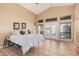 Airy main bedroom with vaulted ceilings, light wood floors, and access to the outdoor patio at 2535 N Pinnule Cir, Mesa, AZ 85215