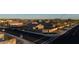 This aerial view shows the neighborhood, surrounding streets, and the home's landscaped backyard at 2583 N Kenna Pl, Casa Grande, AZ 85122