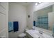 This bathroom features a white sink and vanity, framed mirror, and blue and white accents at 2583 N Kenna Pl, Casa Grande, AZ 85122