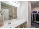 This bathroom features a white sink and vanity, framed mirror, and includes an attached closet at 2583 N Kenna Pl, Casa Grande, AZ 85122