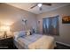 This bedroom features a ceiling fan, neutral walls, and a queen-size bed with cozy linens at 2583 N Kenna Pl, Casa Grande, AZ 85122