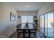 Bright dining area with a sliding glass door, and a large dining table with seating for six at 2583 N Kenna Pl, Casa Grande, AZ 85122