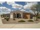 Cozy home featuring desert landscaping, tile roof and a two-car garage with extended driveway at 2583 N Kenna Pl, Casa Grande, AZ 85122