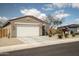 Charming single-story home featuring a two-car garage, desert landscaping, and a tile roof at 2583 N Kenna Pl, Casa Grande, AZ 85122