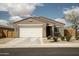 Well-maintained single-Gathering home with a tile roof, two-car garage, and low-maintenance desert landscaping at 2583 N Kenna Pl, Casa Grande, AZ 85122