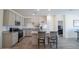 Modern kitchen with gray cabinets, stainless steel appliances, and an island with seating at 2583 N Kenna Pl, Casa Grande, AZ 85122