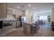 Open-concept kitchen with stainless appliances, a kitchen island with barstool seating, and gray cabinets at 2583 N Kenna Pl, Casa Grande, AZ 85122
