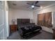 Cozy main bedroom featuring a ceiling fan, lamps, and carpeted floors at 2583 N Kenna Pl, Casa Grande, AZ 85122