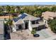 A high-angle view of the two-story house showing the installed solar panels, the driveway, and desert landscaping at 2702 S Beverly Pl, Chandler, AZ 85286