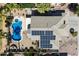 Aerial view of a home featuring a pool, patio, and solar panels at 2702 S Beverly Pl, Chandler, AZ 85286