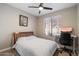 Neutral bedroom featuring a ceiling fan, large window, and dedicated desk area at 2702 S Beverly Pl, Chandler, AZ 85286