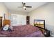 Relaxing bedroom featuring a ceiling fan, dresser, and television at 2702 S Beverly Pl, Chandler, AZ 85286