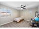 Neutral bedroom featuring a ceiling fan, window, and black desk at 2702 S Beverly Pl, Chandler, AZ 85286