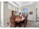 Formal dining room with tray ceilings, neutral paint, and an ornate dining table with seating for eight at 2702 S Beverly Pl, Chandler, AZ 85286