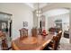 Spacious formal dining area featuring a large wood table, seating for eight, and modern light fixture at 2702 S Beverly Pl, Chandler, AZ 85286