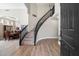 Elegant foyer with beautiful hardwood floors and an elaborate curved staircase with black iron railings at 2702 S Beverly Pl, Chandler, AZ 85286