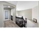 Upstairs hallway showcasing black railings, neutral paint and carpet, and an archway at 2702 S Beverly Pl, Chandler, AZ 85286
