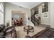Open-concept living room and formal dining area showcasing high ceilings and plush leather sofas at 2702 S Beverly Pl, Chandler, AZ 85286