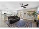 Open-concept living room with kitchen view, plush seating, and outdoor access at 2702 S Beverly Pl, Chandler, AZ 85286