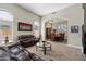 Open-concept living room with high ceilings, neutral colors, and an archway leading to the formal dining area at 2702 S Beverly Pl, Chandler, AZ 85286