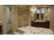 A luxurious bathroom with a soaking tub, dual vanities, and a walk-in shower with upscale tiling at 30556 N Sage Dr, Peoria, AZ 85383